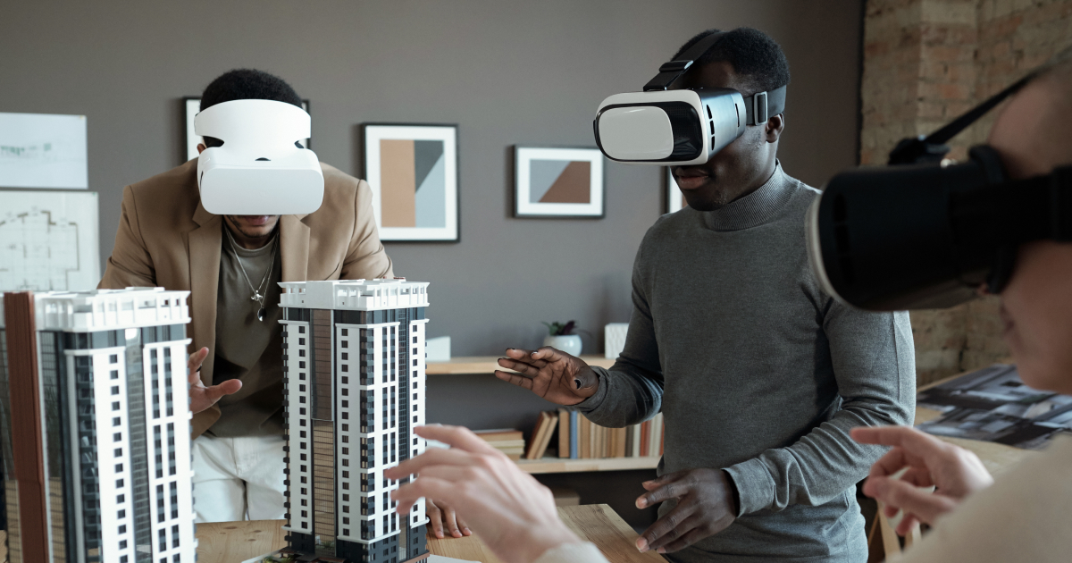 Architects using VR headsets with scale model buildings.